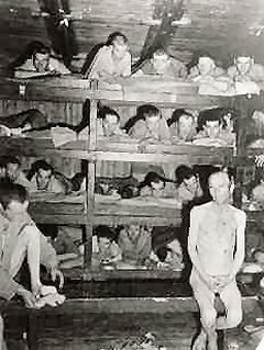 Liberated prisoners demonstrate the overcrowded conditions at the Buchenwald concentration camp, Germany, April 23, 1945.