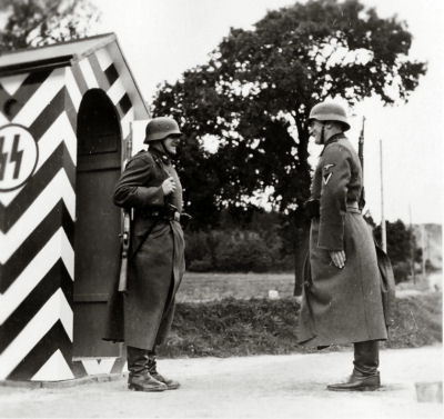Guards stand at attention at a checkpoint at the Gross-Rosen concentration camp, 1941-4.