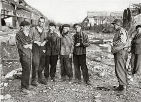 An American soldier speaks outside with five survivors in the Nordhausen concentration camp.